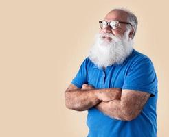 Old man with a long beard on a pastel background. Senior with full white beard. photo