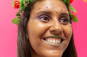 happy young woman with mask and confetti at carnaval party. Brazilian Carnival photo