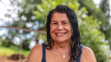 Middle aged woman looking at camera with happy smile photo