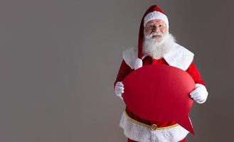 Santa Claus holding blank text balloon. photo