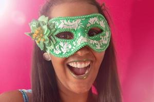 happy young woman with mask and confetti at carnaval party. Brazilian Carnival photo