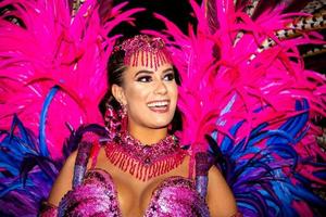 Brazilian wearing Samba Costume. Beautiful Brazilian woman wearing colorful costume and smiling during Carnaval street parade in Brazil. photo