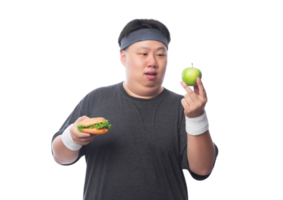 Young Asian funny fat sport man holding hamburger and green apple, Png file