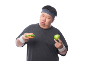 jeune homme de sport gras drôle asiatique tenant un hamburger et une pomme verte, fichier png