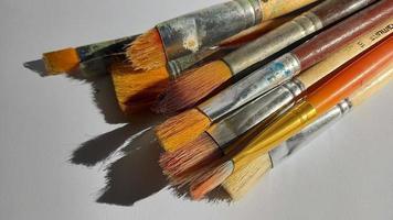A bunch of used paint brushes photo on an empty background