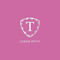 T Letter Intial logo design template. Suitable for Insurance, fashion and beauty product. Luxury silver decorative floral shield illustration. Isolated on pink color background. vector