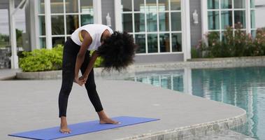 African woman stretching at swimming pool video