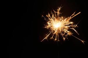 New year party sparkler on black background photo