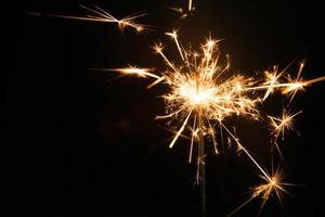 bengala de fiesta de año nuevo sobre fondo negro foto