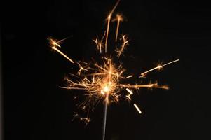 New year party sparkler on black background photo