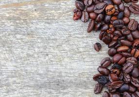 Coffee beans on wood background photo