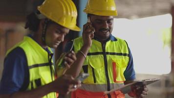 Engineer worker foreman Hispanic indian using telephone calling communication in factory workplace video