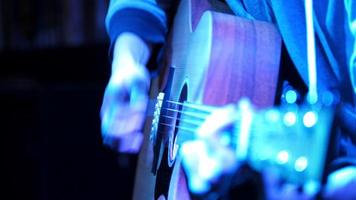 Close up view of guitarist plays acoustic guitar in night club video