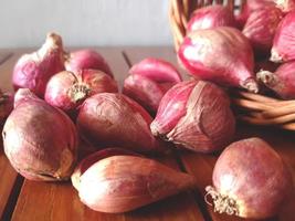 Red onions composition lying on the wooden table photo