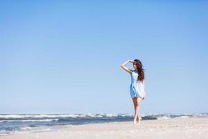 A young girl looking steadily at the sea. photo