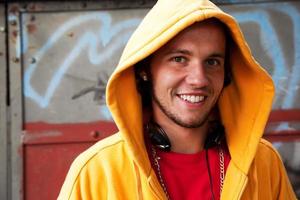 Poland, 2022 - Young man portrait on graffiti grunge wall photo