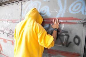 Poland, 2022 - Young man on graffiti grunge wall photo