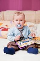 Young baby boy with a dummy in his mouth portrait photo