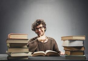 Satisfied student sitting at the desk. photo