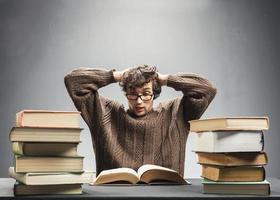 Terrified student reading a book. photo