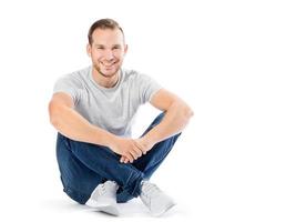 Man sitting with his legs crossed. Smiling guy. photo