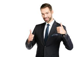Smiling businessman with thumbs up. photo