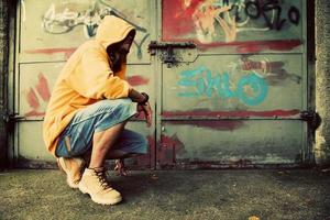 Poland, 2022 - Young man portrait on graffiti grunge wall photo