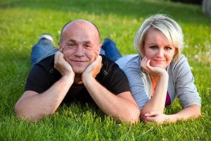 Adult happy couple together on grass photo