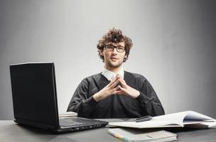 Young serious man sitting in his workplace photo