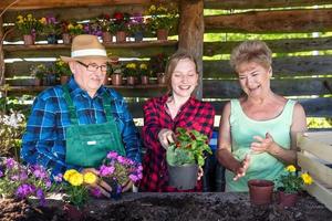 Happy family planting flowers together. photo