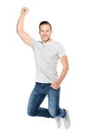 Young man jumping in a joyful expression. photo