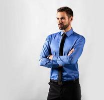 Handsome young businessman standing confident. Isolated on white photo