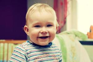 Happy kid laughing looking at the camera photo