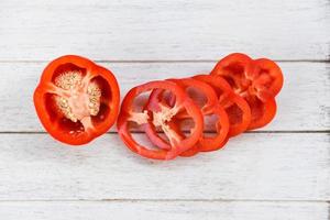 Bell pepper sliced or fresh sweet pepper Red pepper bell on wood white background photo