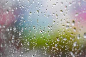 raindrops on glass window in the rainy season, water drop glass background , nature water drop after rain photo