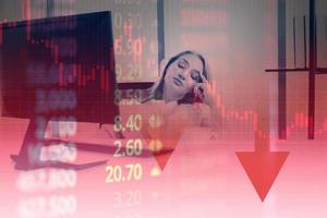 Business crisis economy - Stress business woman look at to monitor show finance crisis stock market chart graph , Stock down trend red price drop arrow down chart fall investment loss crash photo