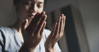 oración de crisis de vida cristiana a dios. mujer reza por la bendición de dios para desear tener una vida mejor. manos de mujer rezando a dios. foto