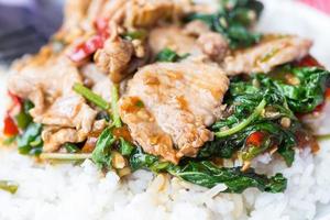 Rice topped with stir-fried pork and basil photo