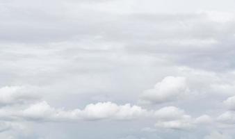 White cumulus clouds on gray sky texture background. Full frame of cloudscape background. Cloudy sky. Beauty in nature. White fluffy clouds. Nature weather. Soft texture like cotton of white clouds. photo