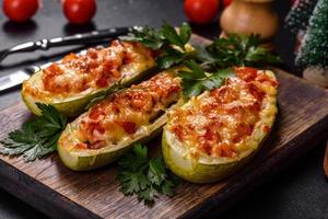 Baked stuffed zucchini boats with minced chicken mushrooms and vegetables with cheese. Christmas table photo