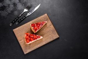 Delicious strawberry tart on concrete background, top view, copy space photo