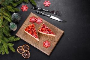 Delicious christmas strawberry tart on concrete background, top view, copy space photo