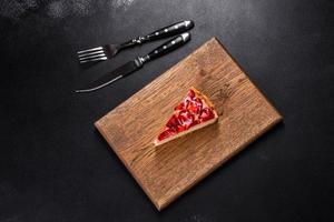 Delicious strawberry tart on concrete background, top view, copy space photo