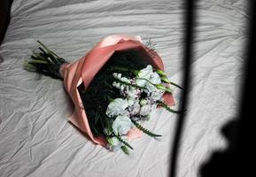 Festive white bouquet of flowers on a white background, against the background of pastel linen, a bouquet of pink color, background, white beautiful flowers photo