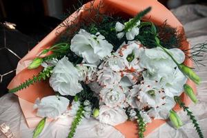 Festive white bouquet of flowers on a dark background, garland, pink color bouquet photo