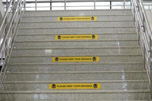 Please keep your distance label on the university stairs or building. real distance label.rectangle yellow labels. photo