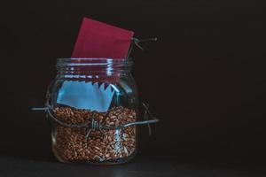 Wheat grain in a jar around barbed wire, the concept of sanctions and the crisis in Qatar, Problems with Qatar grain, the blockade of Qatar grain. photo