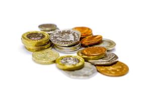 Stack of British currency coins isolate on white background. photo