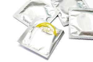 Condom in seal package and opened isolate on white background. photo