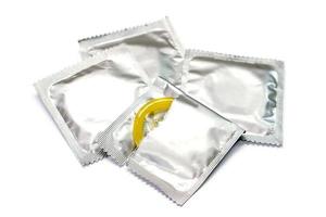 Condom in seal package and opened isolate on white background. photo